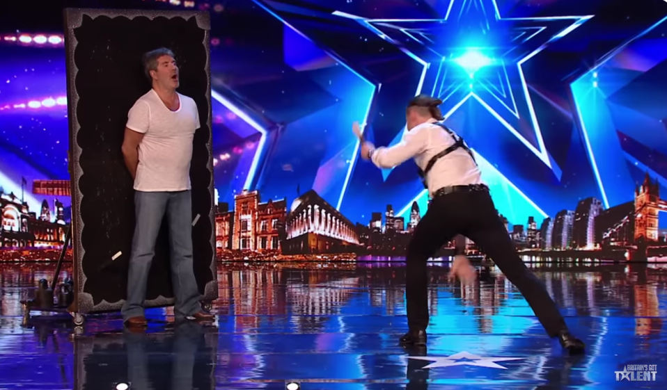 Simon Cowell volunteered to have knives thrown at him but he flinched