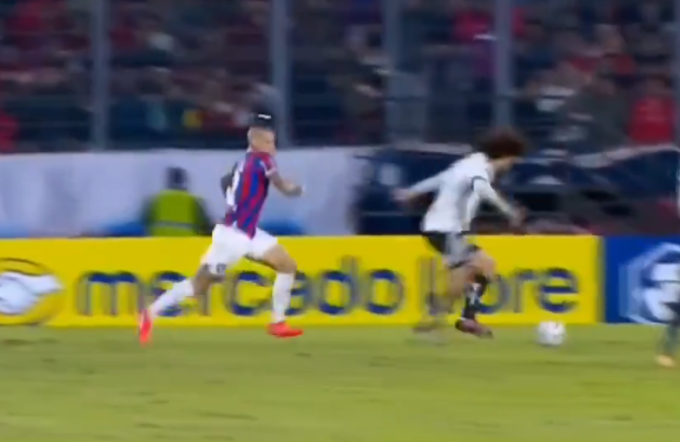 Cerro Porteno full-back Alan Benitez chased after Colo-Colo defender Maximiliano Falcon