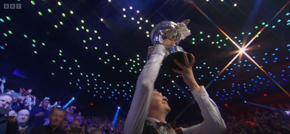 Maiden winner Kyren Wilson holds the trophy aloft