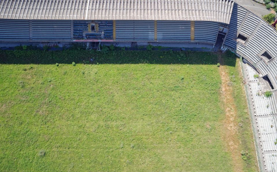 The stadium has been abandoned and the pitch has become overgrown