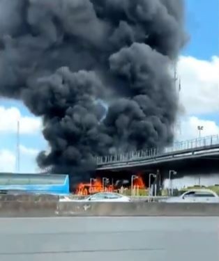 A closer view shows an orange fireball as the coaches burn