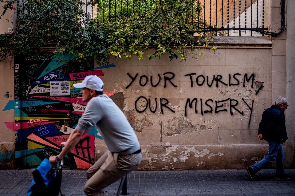 Grafitti in Barcelona reads " Your tourism, our misery"