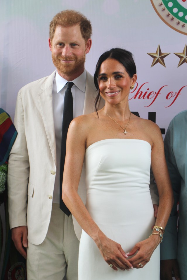 Harry and Meghan pose for a photo as they attend the programme held in the Armed Forces Complex in Abuja