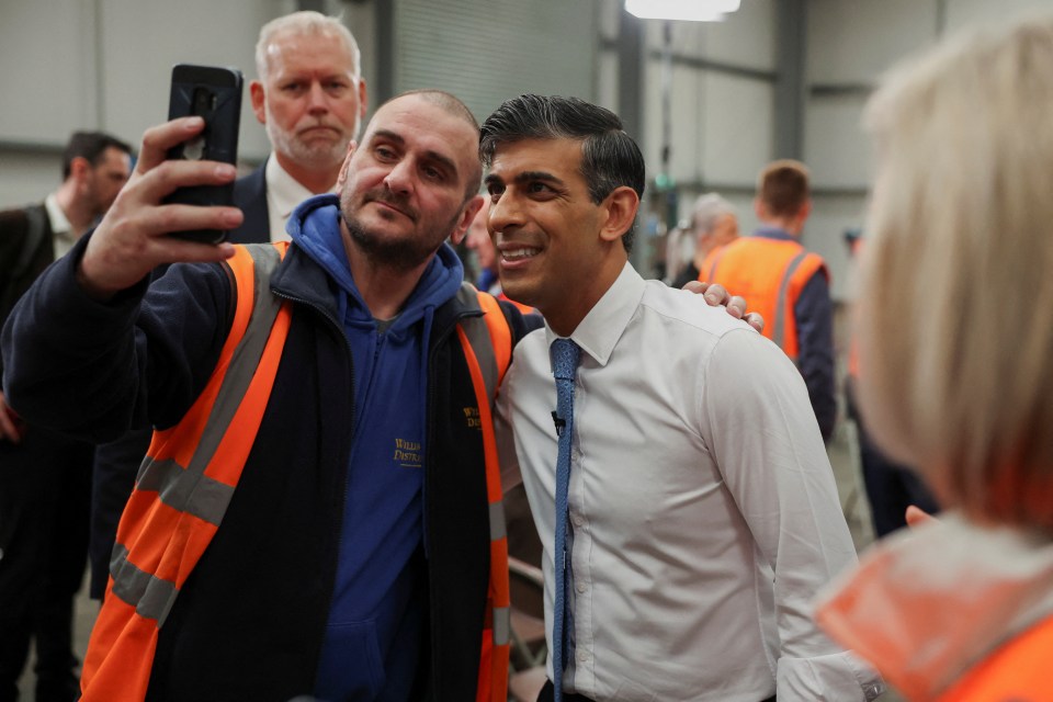 Rishi posing for a selfie with one voter