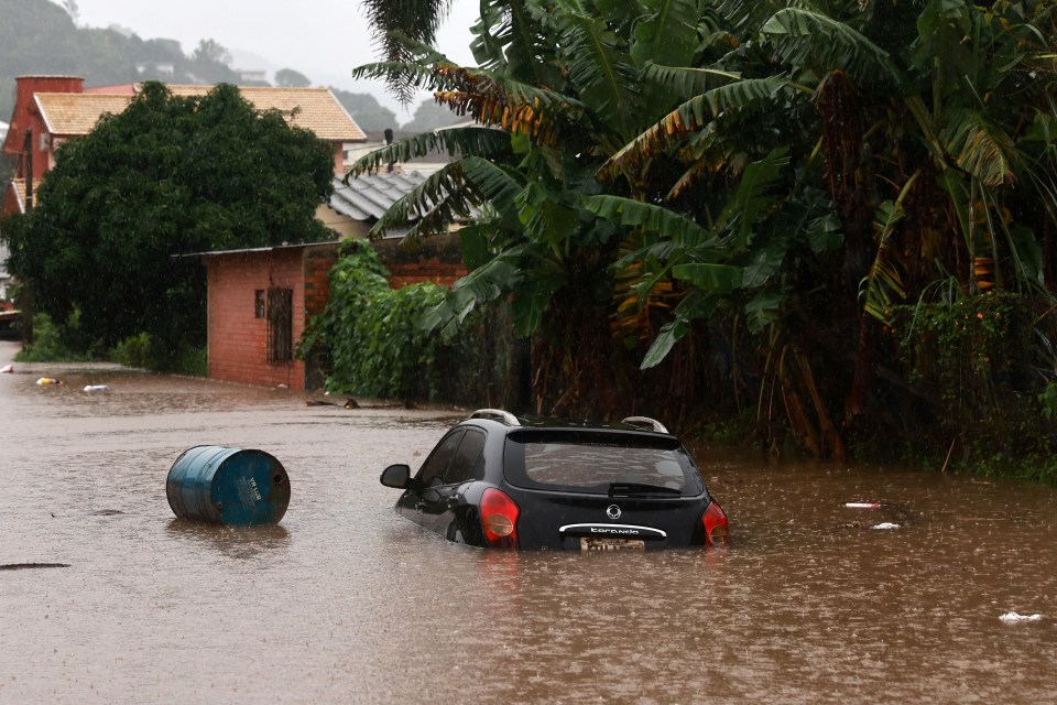 Cars can be seen stranded in the water as rainfalls reach six inches in the region