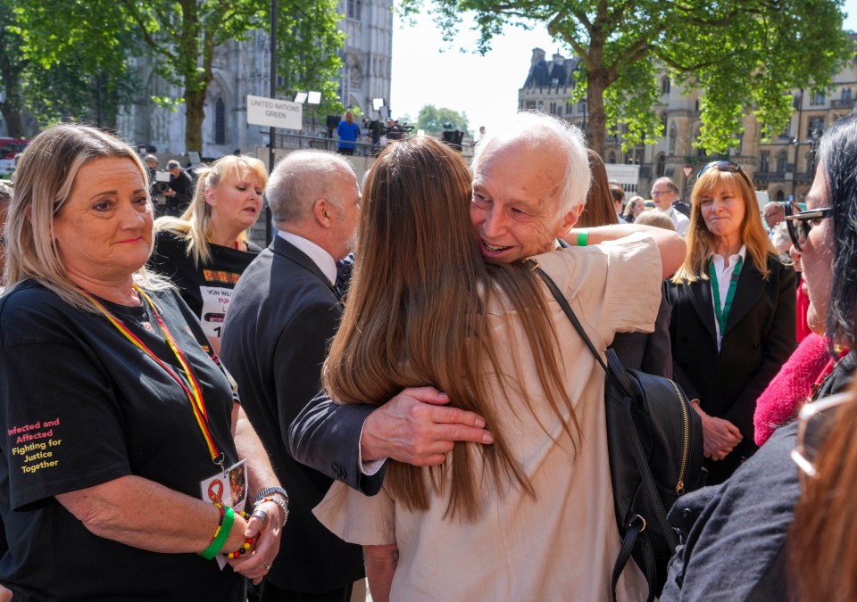 Chairman of the inquiry Sir Brian Langstaff hugs victims and their families