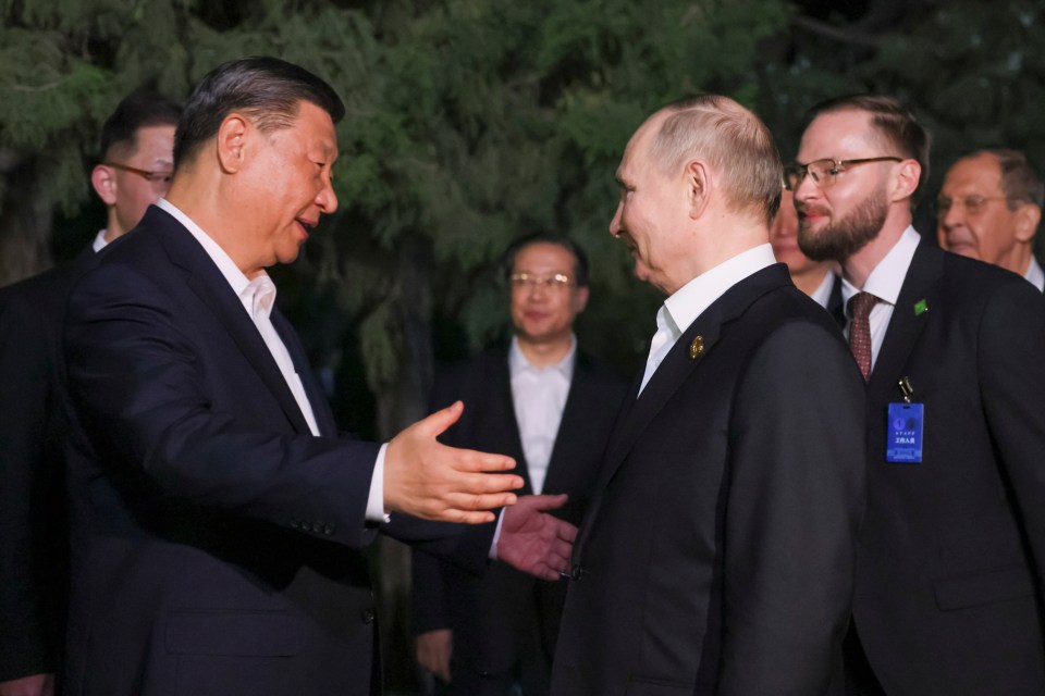 Xi appears to gesture an embrace between the two