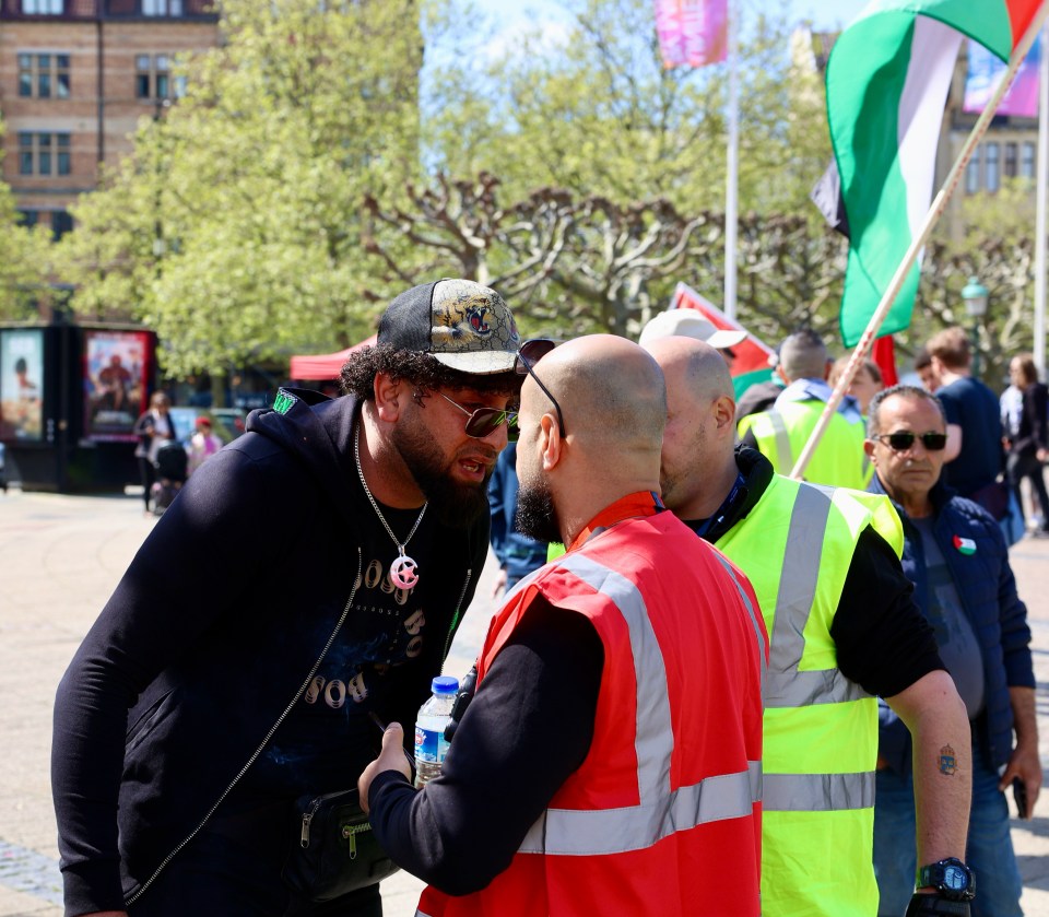 A protester clashes with a security officer outside the town hall in Malmo