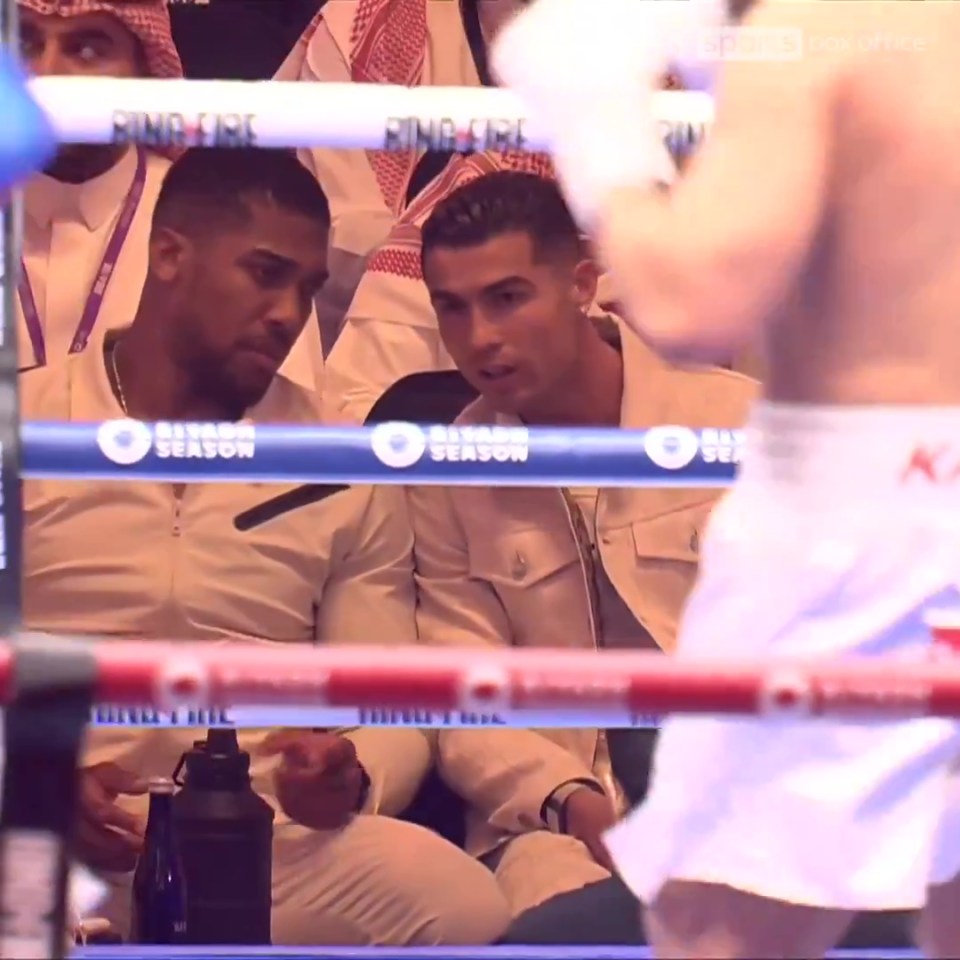 Anthony Joshua and Cristiano Ronaldo captured sharing a moment from ringside