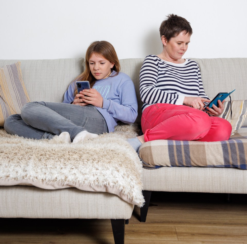 Daisy Dickinson, left, and Becky glued to their phones before they took a break