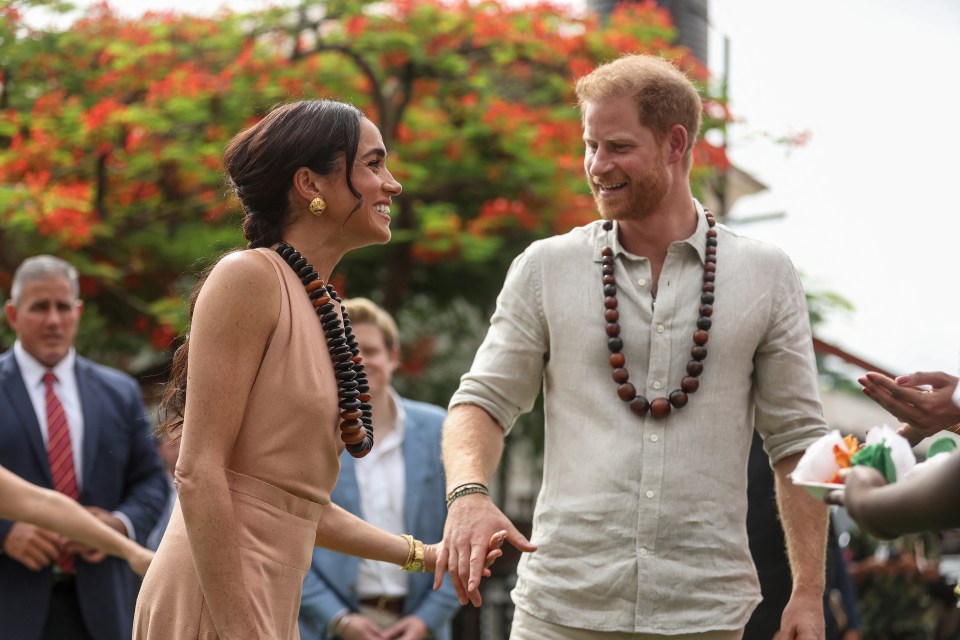 The Sussexes walked hand-in-hand as they greeted people