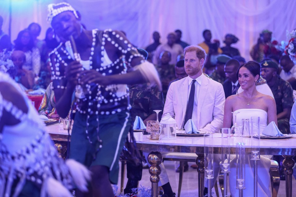 Harry watches on during a dinner at the Nigerian Defence Headquarters in Abuja on May 11