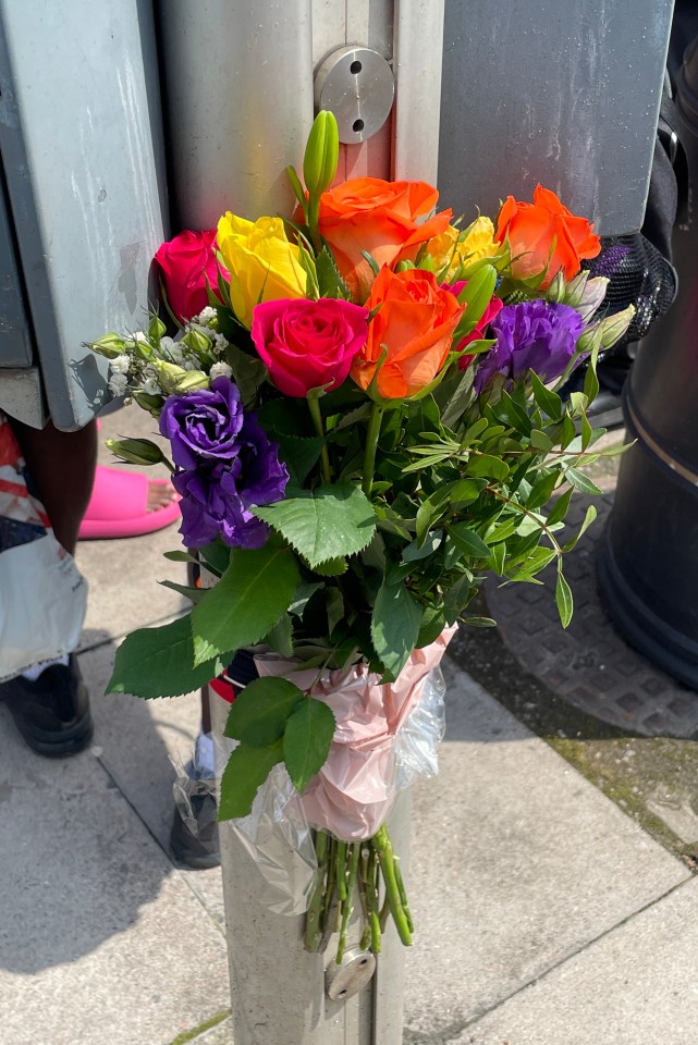 Flowers left at a bus stop near to the scene