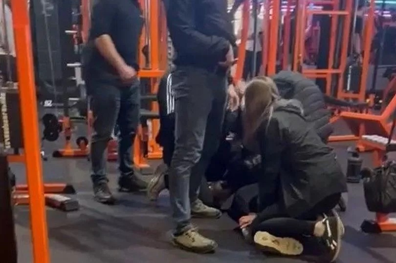 Video caught the suspect pinned by police to the floor of the gym