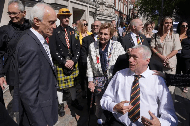 Inquiry chair Sir Brian Langstaff (left) with campaigners and victims Credit: PA