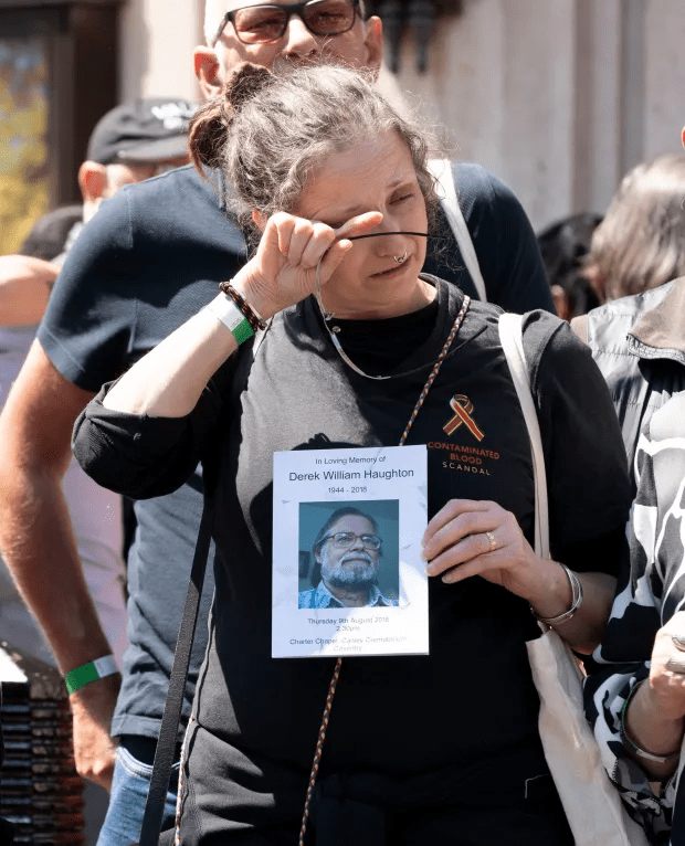 Emotional family members gather outside the inquiry in London Credit: Dan Charity