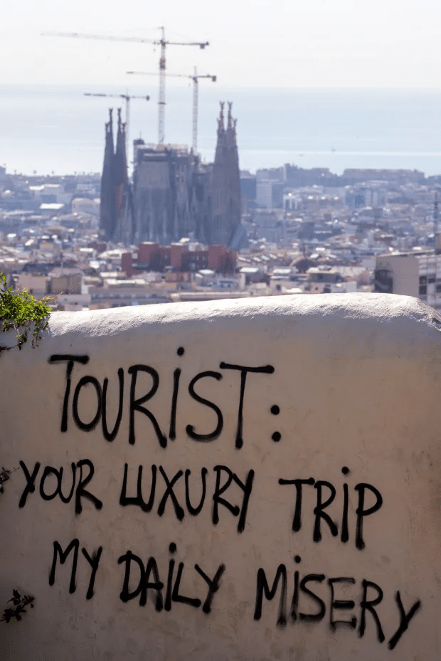 Anti-tourist graffiti in Guell Park in Barcelona