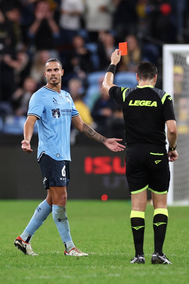 The referee addressed the crowd and players before brandishing the red card