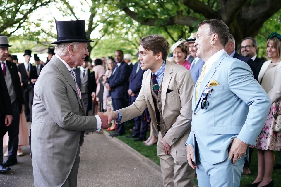 King Charles shakes hands with Barney and Bradley Walsh at the party