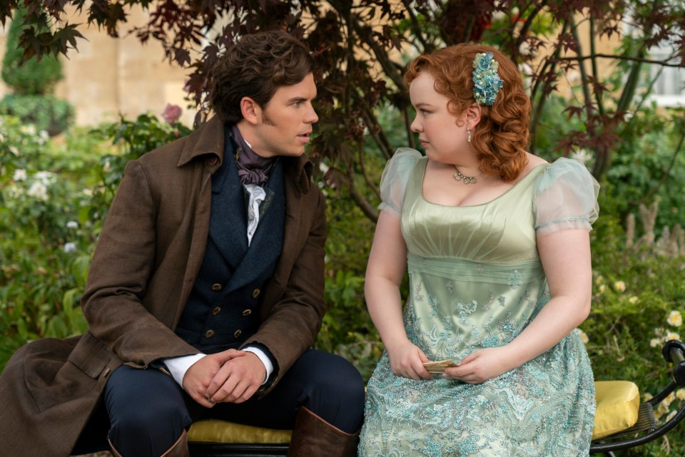 Bridgerton. (L to R) Luke Newton as Colin Bridgerton, Nicola Coughlan as Penelope Featherington in Bridgerton