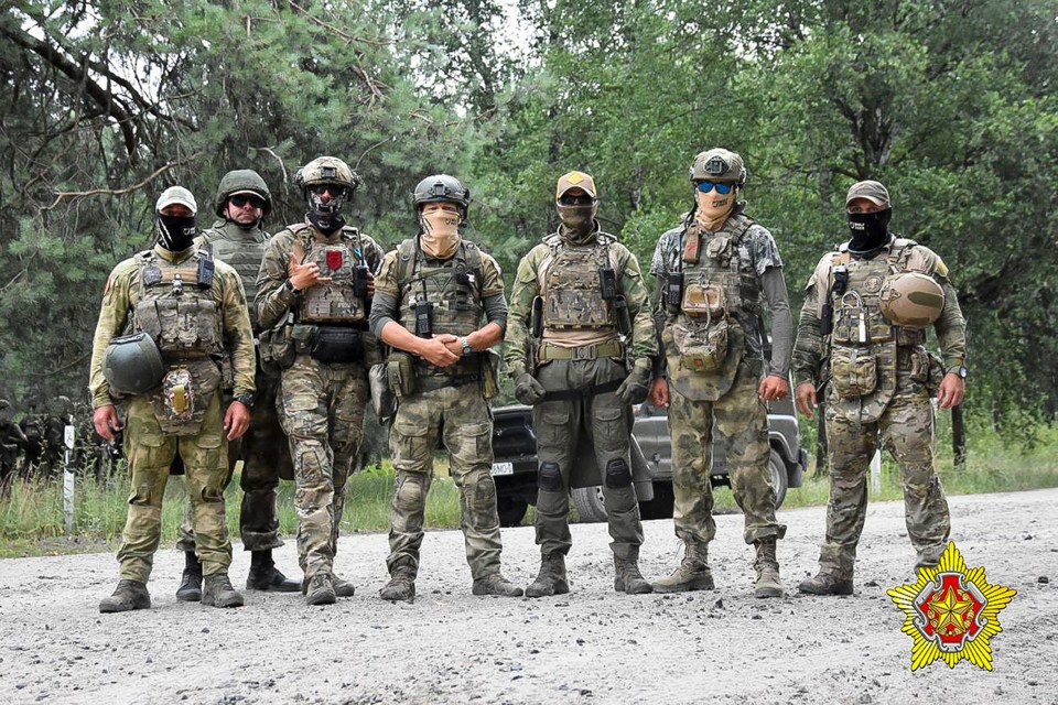 Belarusian soldiers of the Special Operations Forces (SOF) and mercenary fighters from Wagner private military company pose for a photo