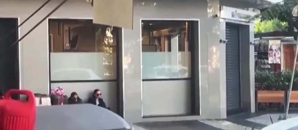 The mum and daughter are seen sitting outside the restaurant with their suitcases