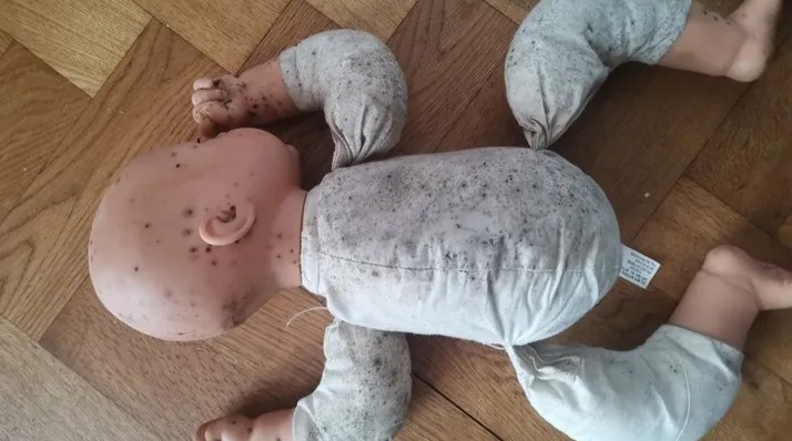 One of her daughter's dolls is pictured covered in the mould