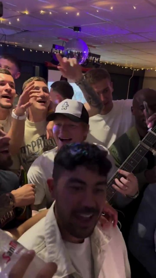 The singer was surrounded by Ipswich players as they sang about "Super Kieran McKenna"