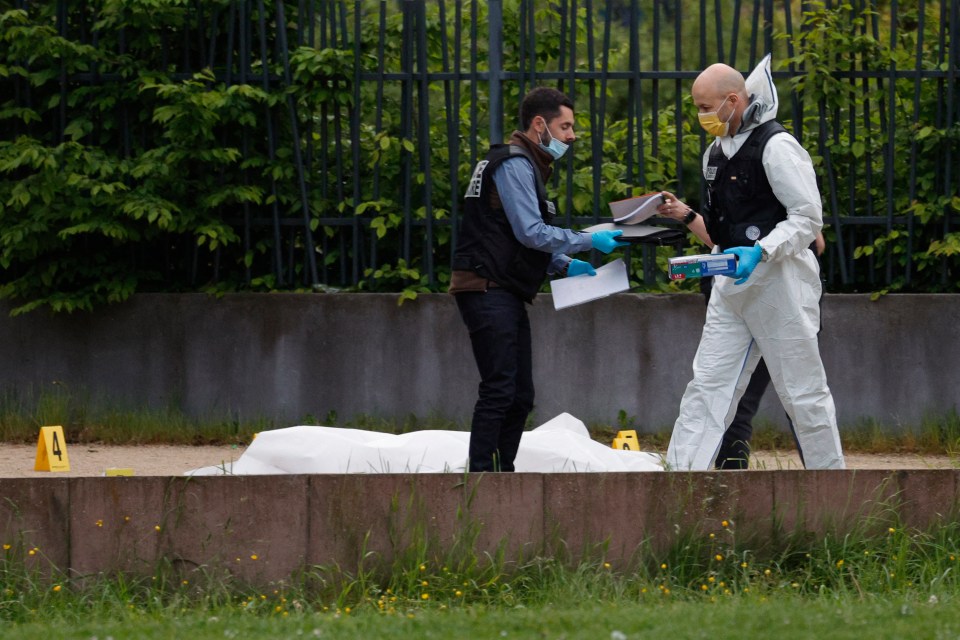 Police examine the scene where two men were shot dead, in Sevran, northern Paris, last week