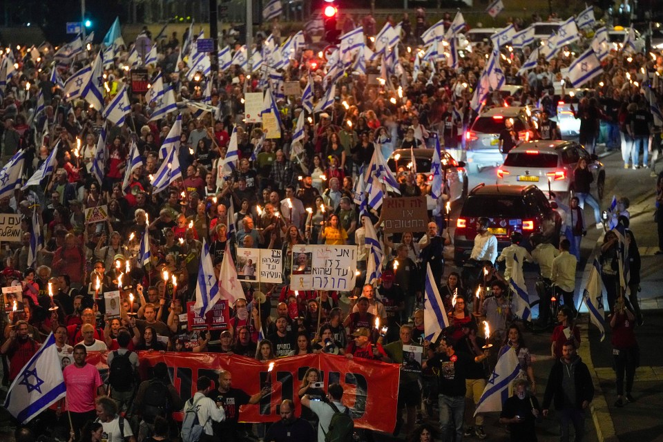 Israelis take part in a protest against Israeli Prime Minister Benjamin Netanyahu's government and call for the release of hostages