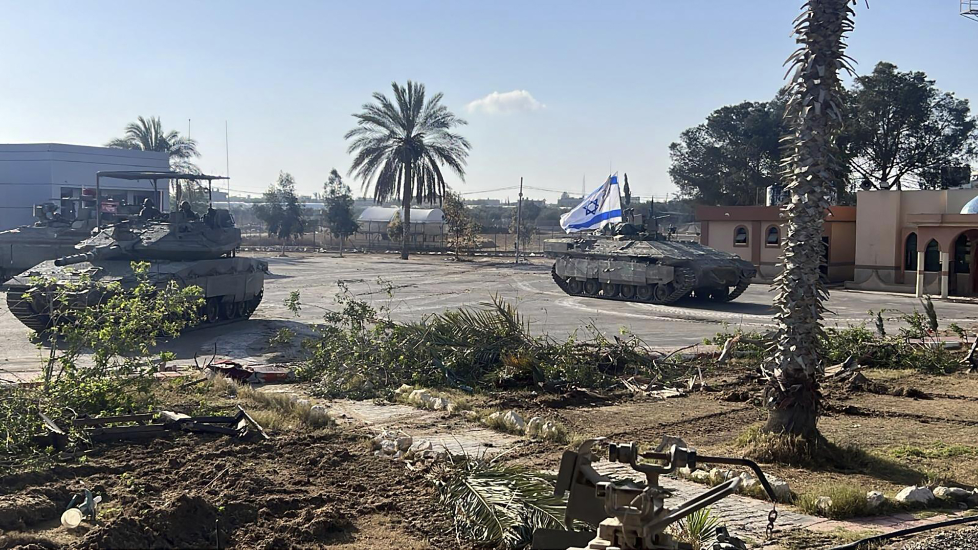 Israeli tanks next to the Rafah crossing after seizing it - a move condemned by the White House