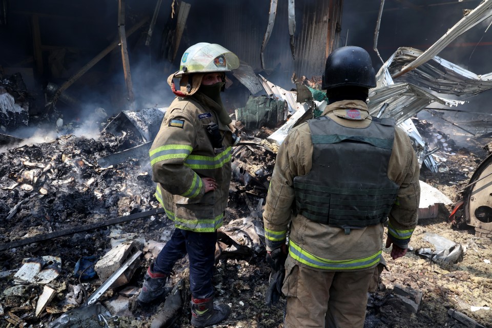 Firemen survey the damage