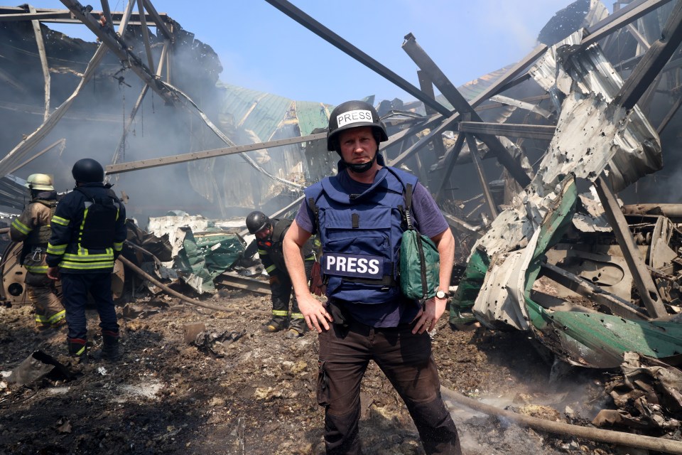 Sun man Paul Sims is pictured at the scene of a bombed-out publishing warehouse