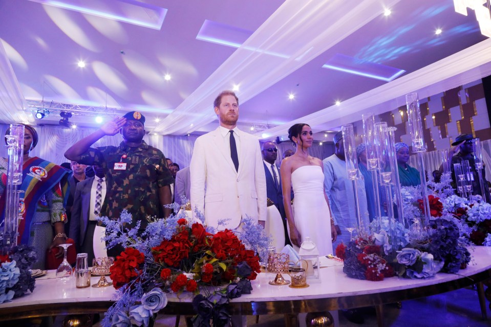 The Sussexes are on the third of a three day 'faux Royal' tour of the African nation - and last night stood for God Save The King at a charity event in Abuja