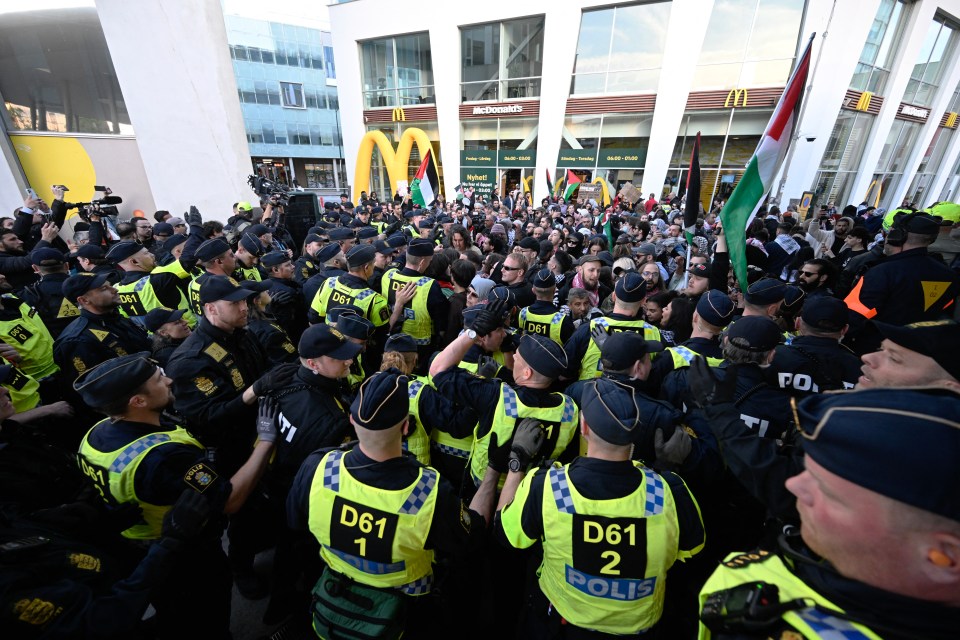 Police perform a barricade in front of Pro-Palestinian protesters outside the Malmo Arena venue ahead of tonight's final