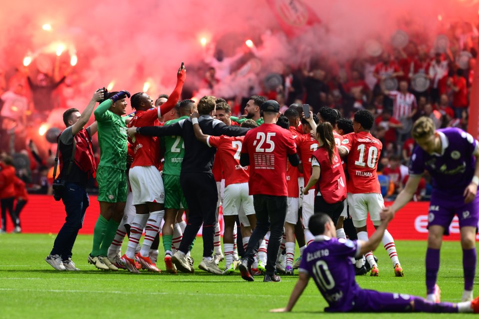 PSV celebrate their title win as fans set off flares all over the stadium