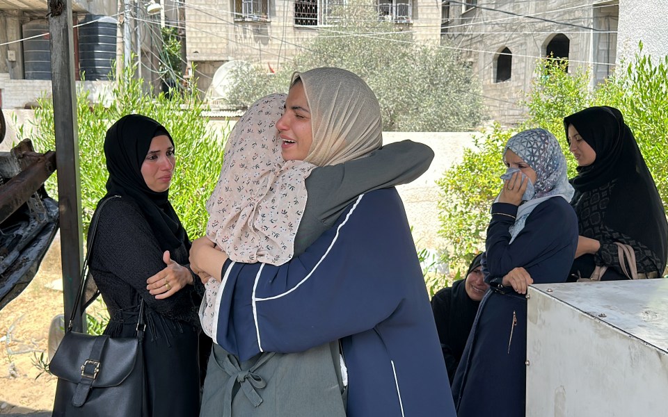 Palestinian civilians comfort each other after losing a loved one in Rafah