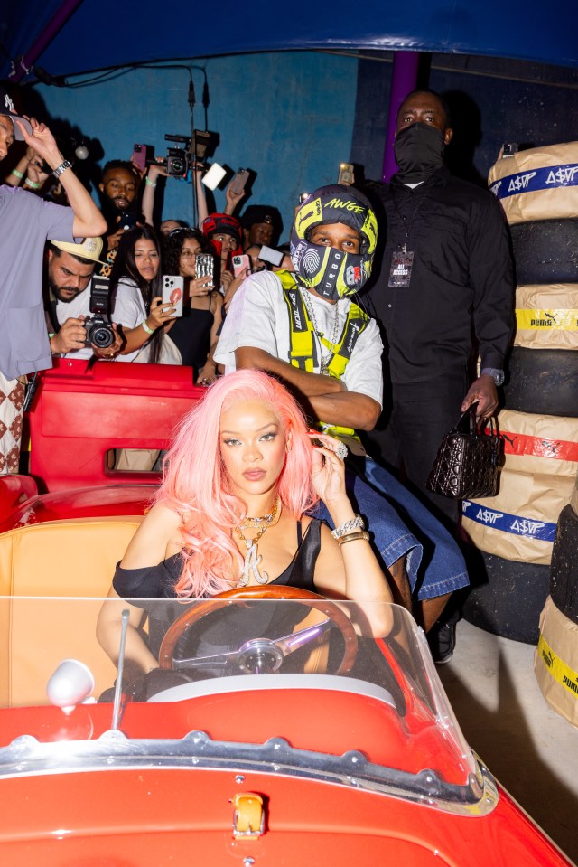 Rihanna posed with A$AP Rocky, who wore a fake helmet at a Formula One party in Miami