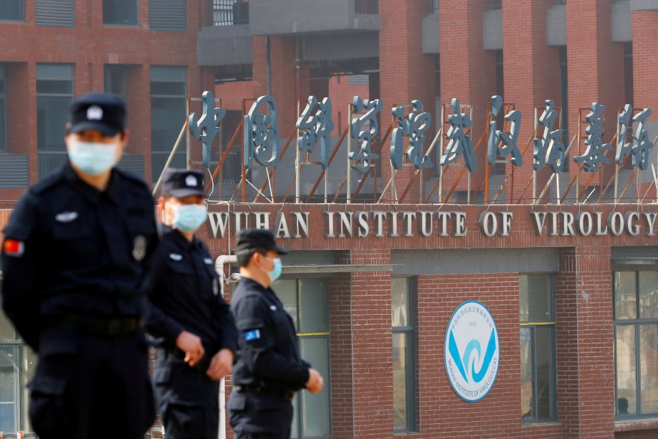 Security guards keeping watch outside the Wuhan Institute of Virology during a visit from the World Health Organisation in 2021