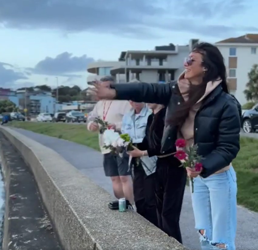 Amie's wife Sian Gray and their daughter paid tribute to her by sprinkling rose petals into the sea at sunset