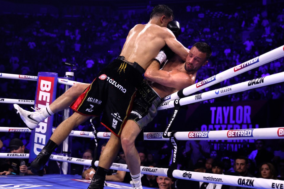 Taylor is pushed onto the ropes by his opponent during the thrilling contest