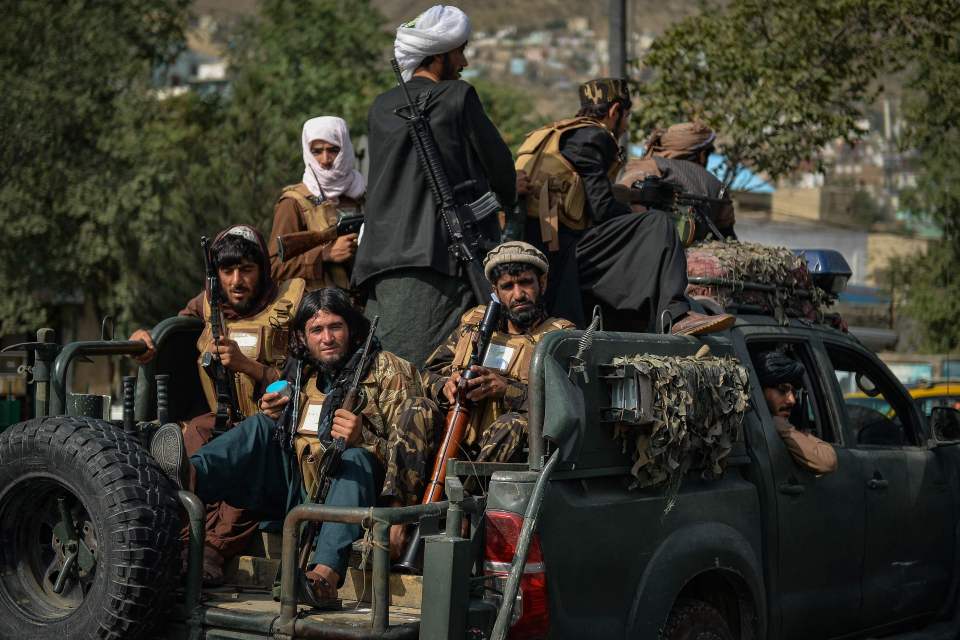 Taliban fighters patrol along a street in Kabul, Afghanistan