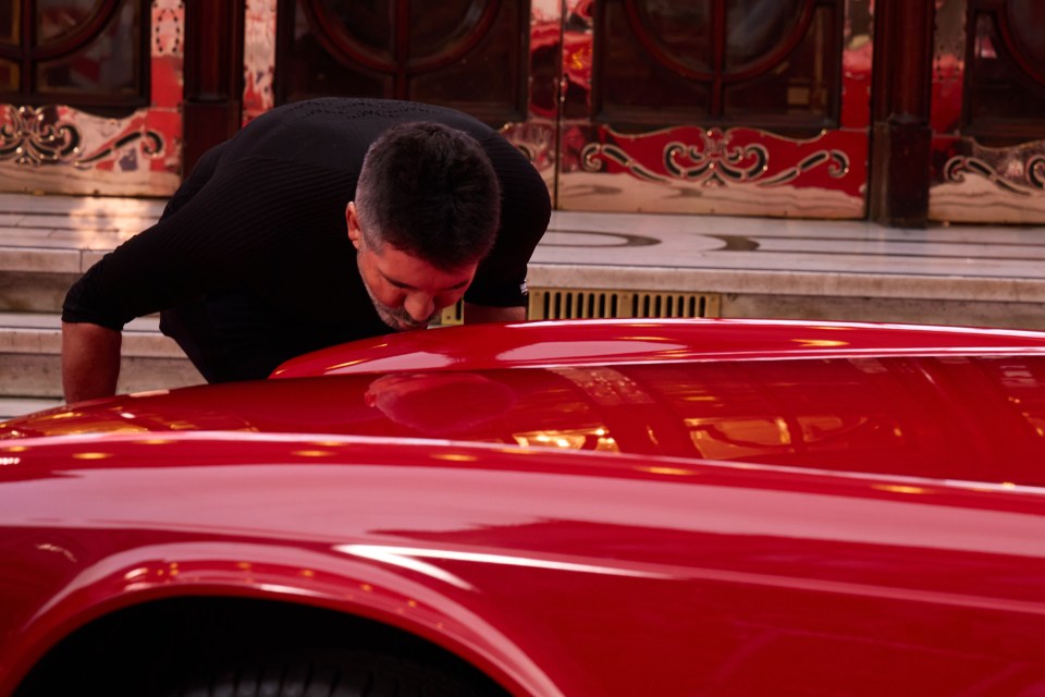 Simon is reunited with the car outside the Palladium and is so revved up he plants a smacker on the bonnet