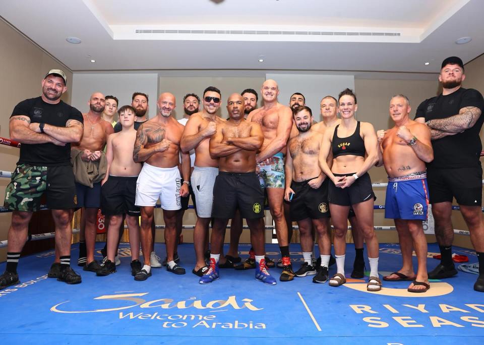 (Left to right) Security guard Brendan lyons, nutritionist Greg Marriott, Tyson's eldest son Prince, coach Kristian Blacklock, Tyson's eldest brother John, brother Hughie Fury, coach SugarHill Steward, brother Shane Fury, Tyson Fury, sparring partner Alex Barriere, massage therapist Matt Towey, boxing trainer Bob Howard, training partner Jelena Mrdjenovich, coach Steve Egan, unknown security guard