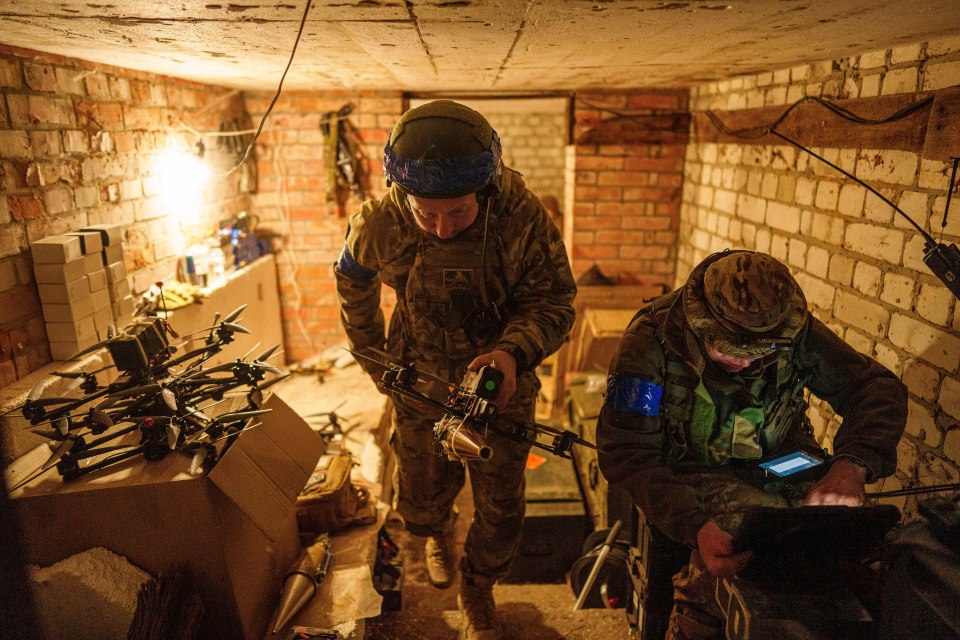 A soldier of Ukrainie's 92nd brigade carries a suicide drone in the Kharkiv region