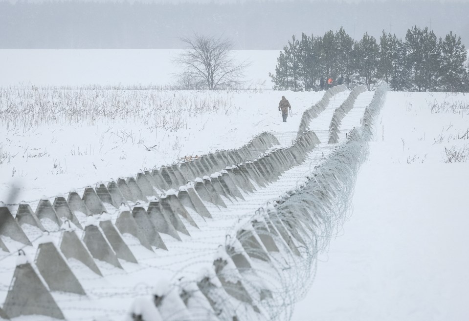 Ukrainian troops check newly build anti tank fortifications, named 'dragon's teeth' and razor wire