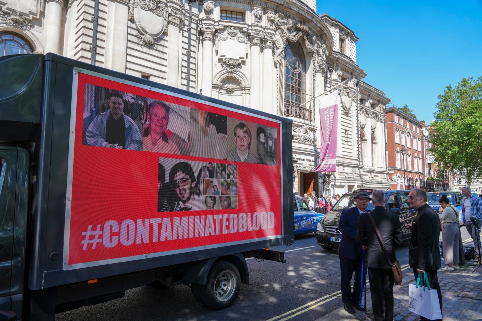 A van with a poster on outside Central Hall in London