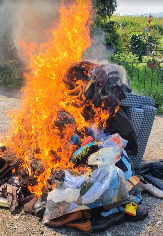 The burning pile of clothes in the garden