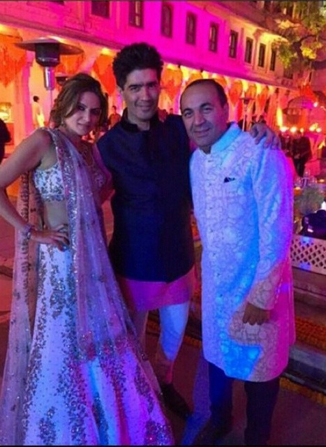 Anu and Sanjay Hinduja pictured with Indian fashion designer Manish Malhotra at their lavish wedding in 2015