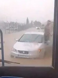 One man could be seen standing on the outside of his car to avoid the high water levels